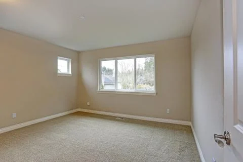 Light beige empty room interior with a window. Stock Photos