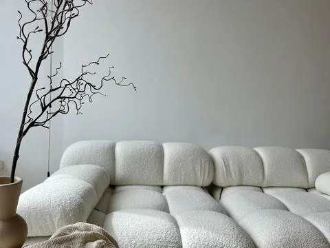 A light beige sofa as part of the decor of a modern interior Stock Photos