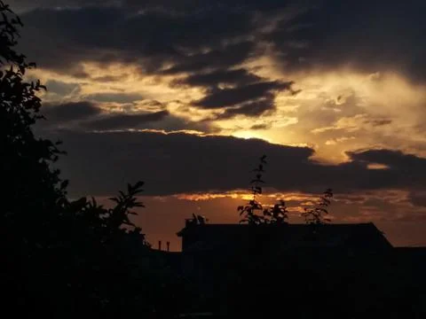 Light Between Shadows: The Drama of the Evening Sky Over the City Stock Photos