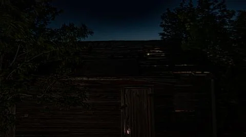 Light bleeding through cracks of garden shed at sunset in rural Manitoba, Canada Stock Photos