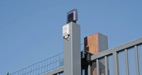 Light Blinking As Automatic Sliding Gate Opens Against Sunny Blue Sky Video stock 146565305