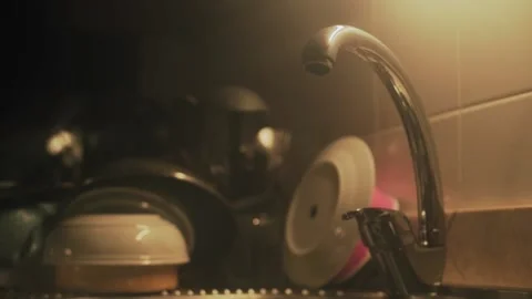 Light blinking on a kitchen with a faucet and a crockery background Video stock 234523314
