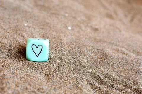 Light blu cube with heart and weather symbols on sides. Funny gambling dice on Stock Photos