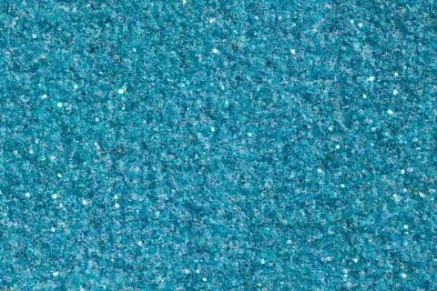 Light blue background with glitter close-up. Bright glitter texture. Stock Photos