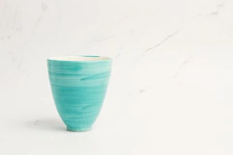 A light blue ceramic cup on a marble background Foto stock