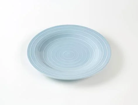 Light blue ceramic dinner plate on plain background Stock Photos