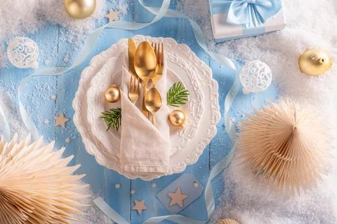 Light blue Christmas table with snow and ornaments. Stock Photos