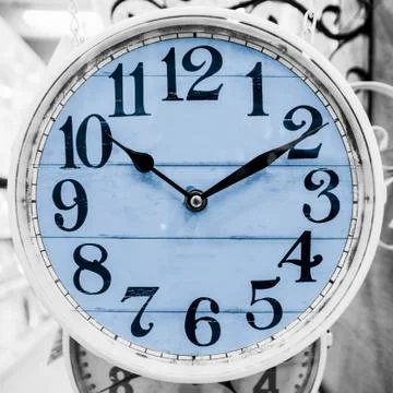 Light blue clock in a classical style. Stock Photos