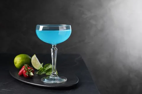 Light blue cocktail served on dark table, space for text Stock Photos