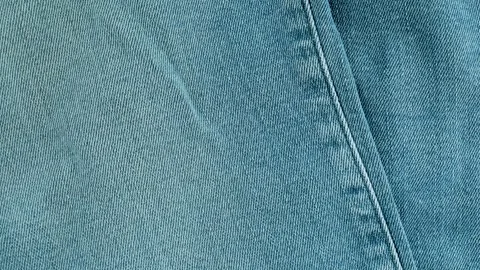 Light blue denim fabric jeans texture moving background Stock Footage 340926579
