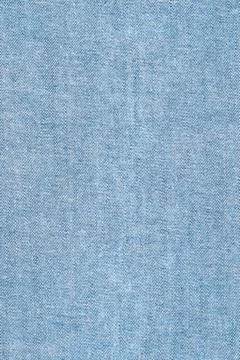 Light blue denim fabric texture closeup with diagonal weave pattern Stock Photos