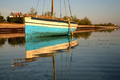 Light blue dhow and reflection Stock Photos