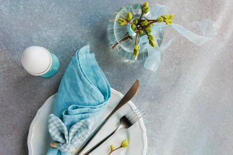 Light Blue Easter Table Setting with Blooming Twig Foto stock