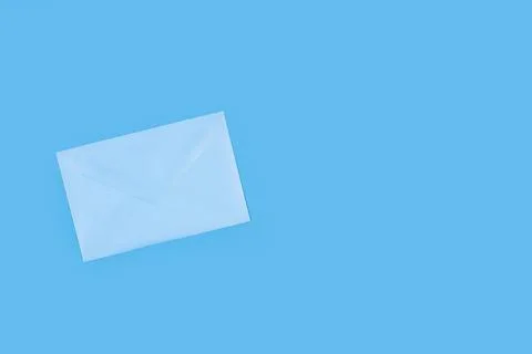 A light blue envelope on a blue background with copy space Stock Photos