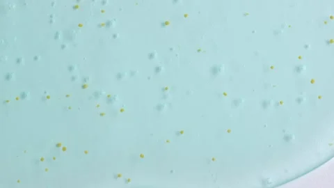 Light blue exfoliant gel texture. Transparent cosmetic gel with bubbles and.. Stock Footage 263719262