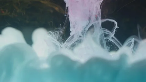 Light blue paint diffusing in water Stock Footage 100018641
