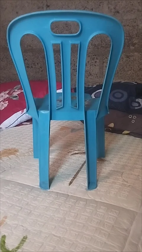 Light blue plastic sitting chair Stock Footage 294460739