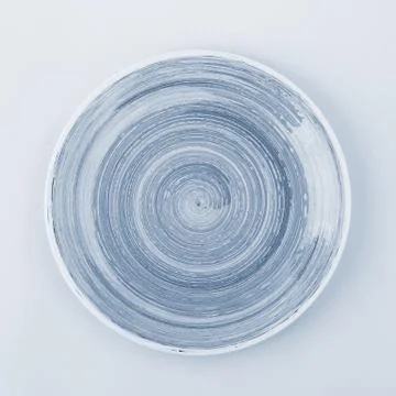 Light blue plate on the light background Stock Photos