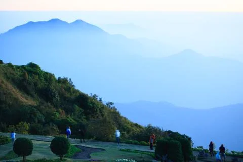 Light blue shines down around the blue mountain. Stock Photos