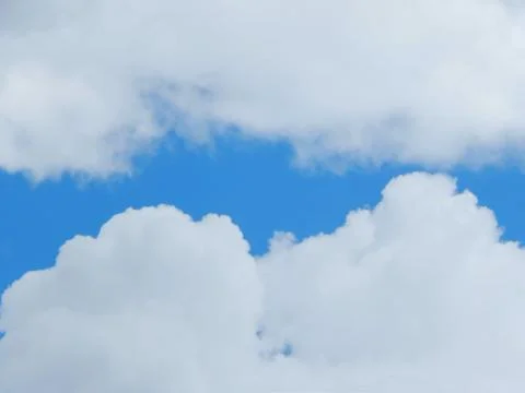 Light blue sky with clouds, horizontal photo Stock Photos