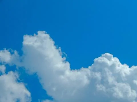 Light blue sky with clouds, horizontal photo Stock Photos