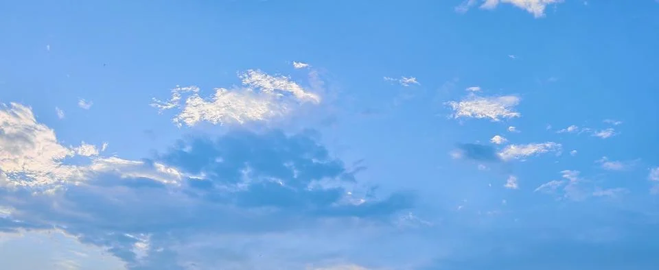 Light Blue Sky with Soft Clouds Stock Photos