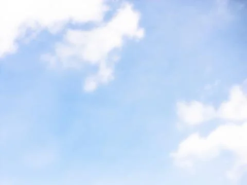 Light Blue Sky With Soft White Clouds Along the Edges Stock Photos