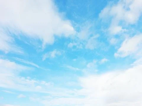 Light blue sky with white clouds on a sunny day Stock Photos