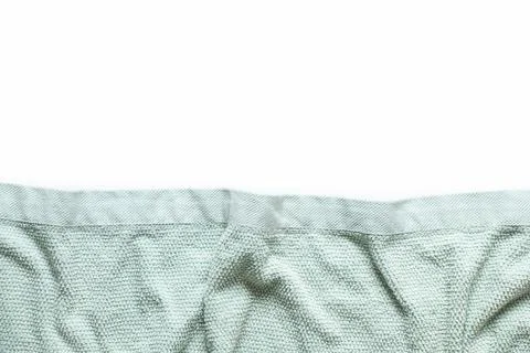 Light blue soft crumpled bath towel as background on white background Stock Photos