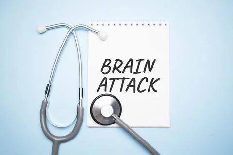 On a light blue table there is a stethoscope, a pen and a sheet of paper with Stock Photos