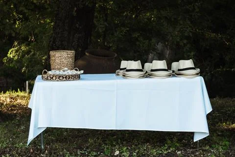 Light blue tablecloth draped over a simple outdoor table Stock Photos