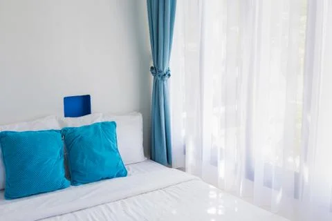 Light blue theme pillows white bedroom light curtain Stock Photos