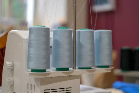 Light blue thread spools mounted on sewing machine Stock Photos