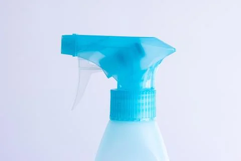 Light blue trigger atomizer bottle close up shot isolated on bright backgroun Fotos de archivo