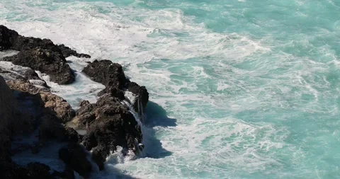 Light blue water waves splashing into the rocks in Porto Katsiki Lefkada. Windy Stock Footage 220682013