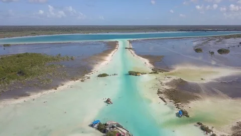 Light Blue/Turquoise Water Passing Through Canal From Lagoon to Ocean Stock Footage 89881825