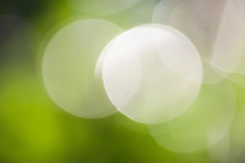 Light bokeh, green background. Stock Photos