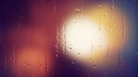 Light bokehs while rain drops on glass Stock Footage 105681629