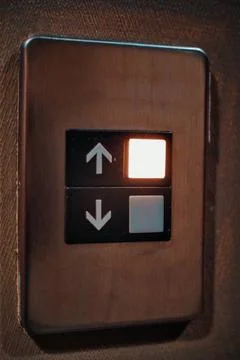 Light Up Botton Going Up Arrow On The Elevator In A Building Foto stock