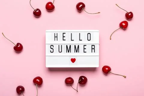 Light box with Hello Summer text and ripe cherries on pink background. Hello Stock Photos