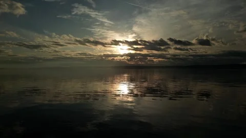 Light breaking through the clouds with reflection on water Stock Footage 294707259