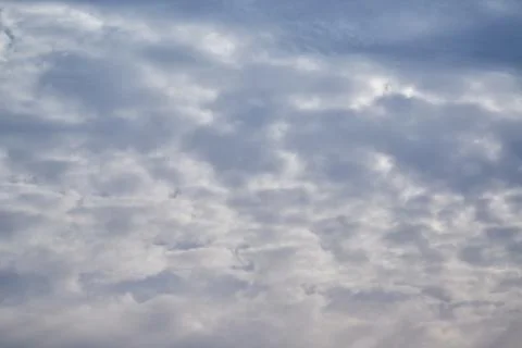 Light breaks through gray clouds in the sky Stock Photos