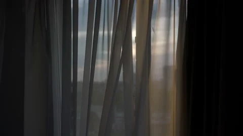 Light breeze blowing through opened window frame at sunset Video stock 156440545