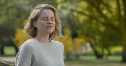 Light breeze going through the hair of a pretty woman Stock Footage 106929302