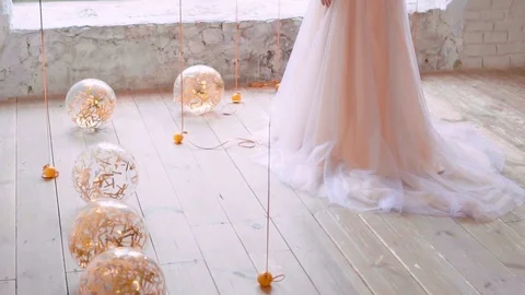 Light bright balloons lie and roll on floor, filled with golden serpentine Stock Footage 100193809