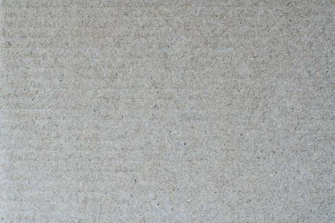 Light brown abstract background from sheet recycled cardboard. Close-up detail Stock Photos
