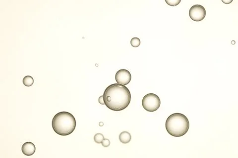 Light brown air bubbles soars over a blurred background. Stock Photos