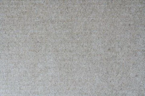 Light brown background from sheet of recycled cardboard. Closeup Stockfoto's