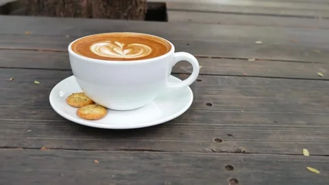 A light brown fresh mocha with a pretty latte art outdoors on a cafe in Paris. Stock-Footage 334648814