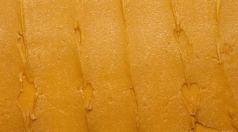 Light brown peanut paste made from whole nuts.Peanut paste background top view. Stock Photos